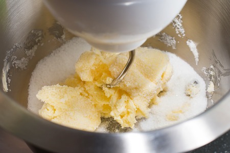 Mixing butter and sugar in mixing machine, homemade bakery, close upの写真素材