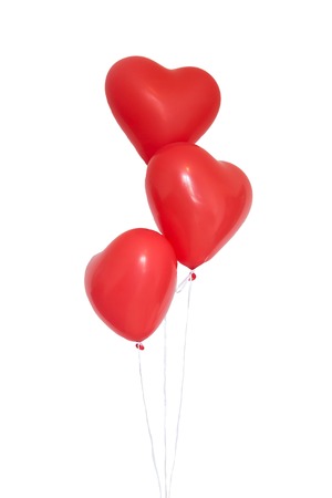 Romantic or festive concept. Three heart shaped red balloons on white backgroundの写真素材
