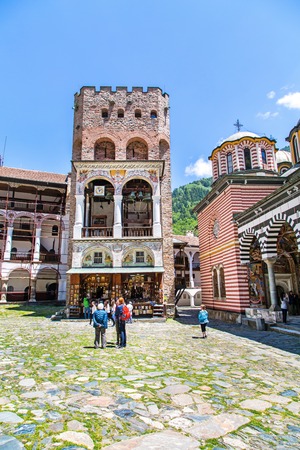 Rila, Bulgaria - June, 25, 2015: People near the icon shop and bell tower in Unesco World Heritage site famous Rila Monastery, Rilsky monasteryのeditorial素材