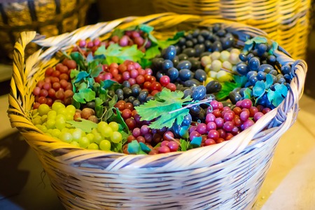 Baskets with the colorful Grapes in old wine cellarの写真素材