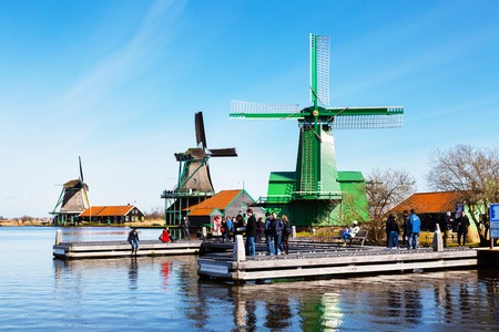 Zaanse schans, Netherlands - April 1, 2016: Windmills in Zaanse Schans, North Holland, traditional village, tourists, blue skyのeditorial素材