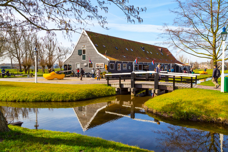 Zaanse schans, Netherlands - April 1, 2016: Wooden shoes, clogs or klompens museum, Zaanse Schans village, Holland, people aroundのeditorial素材