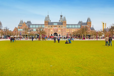 Amsterdam, Netherlands - March 31, 2016: People, grass field  and view of Rijksmuseum, Museumpleinのeditorial素材