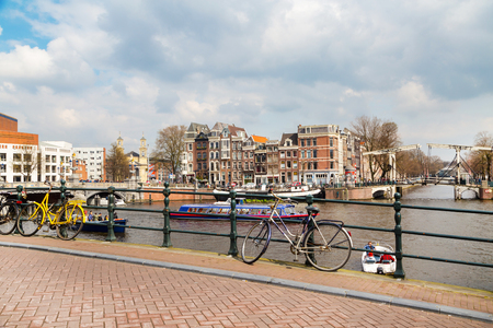 Amsterdam, Netherlands - April 2, 2016: Traditional old buildings, canal and bridge view with bicycles in Amsterdam, the Netherlandsのeditorial素材