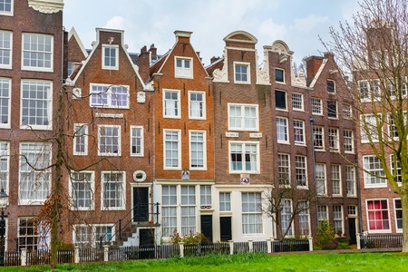 Amsterdam, Netherlands - March 31, 2016: Colorful view of Begijnhof courtyard with historic Holland houses in Amsterdam, Netherlandsのeditorial素材