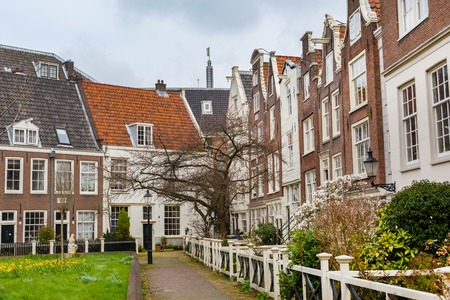 Amsterdam, Netherlands - March 31, 2016: Colorful view of Begijnhof courtyard with historic Holland houses in Amsterdam, Netherlandsのeditorial素材