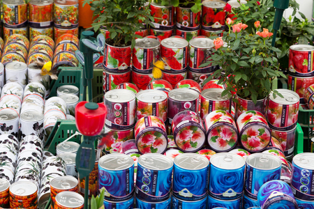 Amsterdam, Netherlands - March 31, 2016: Flower multi-colored cans with roses, souvenirs for sale in Amsterdam, Netherlandsのeditorial素材