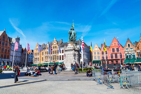 Bruges, Belgium - April 10, 2016: Market place or Grote Markt square with colorful traditional houses, people walking in popular belgian destinationのeditorial素材