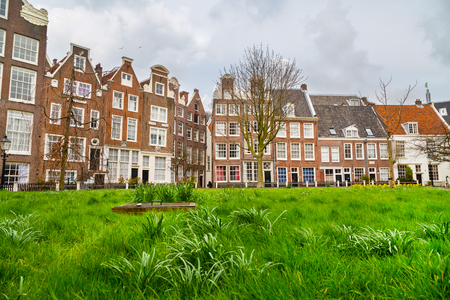 Amsterdam, Netherlands - March 31, 2016: Colorful view of Begijnhof courtyard with historic Holland houses in Amsterdam, Netherlandsのeditorial素材
