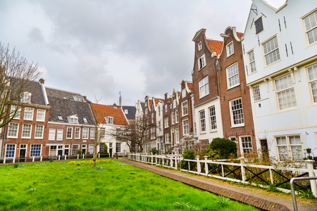 Amsterdam, Netherlands - March 31, 2016: Colorful view of Begijnhof courtyard with historic Holland houses in Amsterdam, Netherlandsのeditorial素材