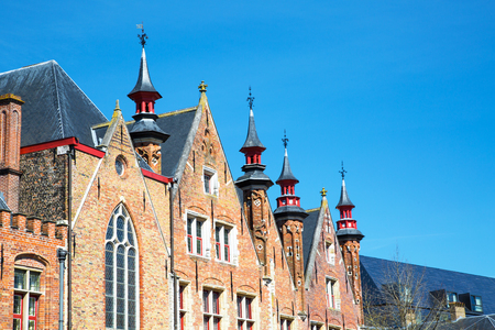 Traditional medieval  brick house exterior against blue sky in Brugge, Belguimn with copy spaceのeditorial素材