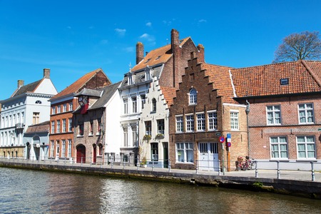 Bruges, Belgium - April 10, 2016: Panorama with canal and colorful traditional houses against blue sky in Brugge, Belguimのeditorial素材