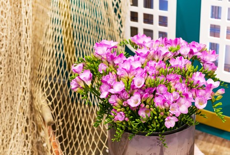 Vibrant flower close-up bouquet of pink alstroemeria background still-life with fishing netの写真素材