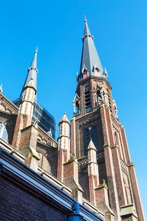 Colorful view of church tower in in downtown of popular Holland destination Delftの写真素材