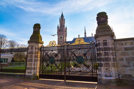Gate of Peace Palace at Hague, Netherlands at sunset and bird symbol of news, flyingのeditorial素材