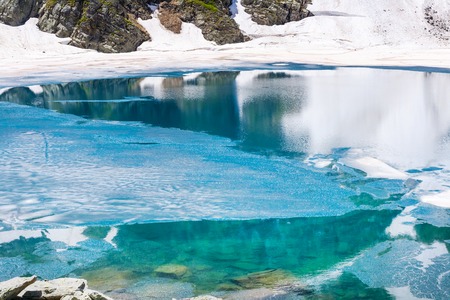 Floating melting ice blocks at the lake in spring