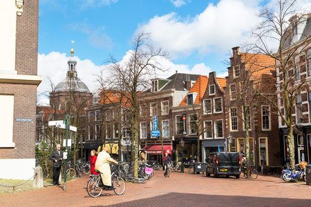 Leiden, Netherlands - April 7, 2016: Traditional houses, Street view and people riding bicycles in Leiden, Holland, Netherlandsのeditorial素材