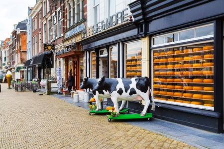 Delft, Netherlands - April 6, 2016: Typical dutch image of cows and cheese for sale in the shopのeditorial素材
