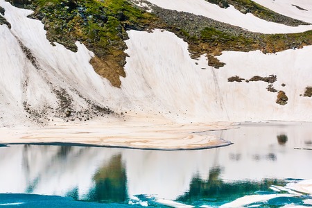 Floating melting ice blocks at the mountain lake in springの写真素材