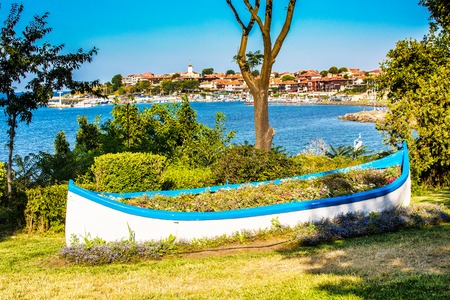 Boat with flowers and old town panorama in Nessebar or Nesebar in Bulgaria, Black seaの写真素材