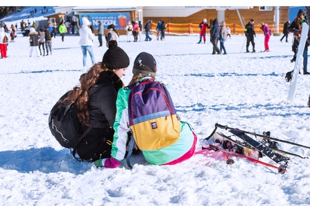 Bansko, Bulgaria - December, 12, 2015: Two lady skiers rest sitting on the snow at ski resort Bansko, Bulgariaのeditorial素材