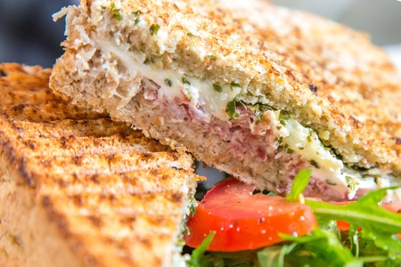 Healthy eating, dieting and cooking concept, close up of sandwich with whole-grain bread, tomatoes, green leafsの写真素材