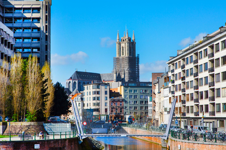 Ghent, Belgium - April 12, 2016: Houses, canal and tower of St Bavo's Cathedral in popular touristic destination Ghent, Belgiumのeditorial素材