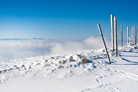 Panorama of white snow mountain landscape with fog and cloudsの写真素材