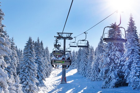 Kopaonik, Serbia - January 22, 2016: Ski resort Kopaonik, Serbia, people on the ski lift among the snowy white pine treesのeditorial素材