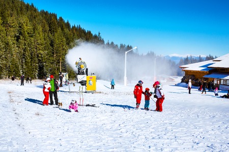 Bansko, Bulgaria - December 12, 2015: Ski resort Bansko, ski slope with people walking and skiingのeditorial素材