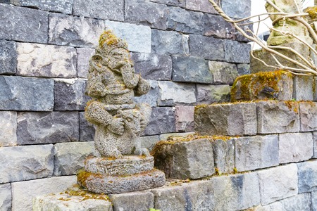 Statue of ganesha hindu god and ancient temple wall, asian induism background