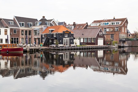 Haarlem, Netherlands - April 2, 2016: Picturesque landscape with beautiful traditional houses reflection in canal, Haarlem, Hollandのeditorial素材
