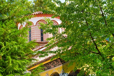 Church in Bachkovo Monastery, Bulgaria and green treeの写真素材
