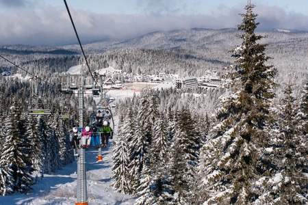 Kopaonik, Serbia - January 22, 2016: Ski resort Kopaonik, Serbia, ski slope, people on the ski lift, mountains, houses and buildings panoramaのeditorial素材