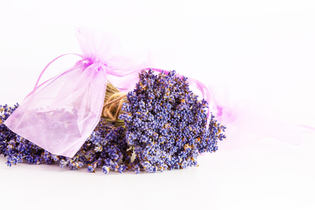 Making aroma bags, bunch of dry wild mountain lavender flowers and wooden bowlの写真素材