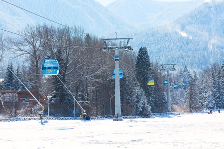 Bansko, Bulgaria - November 30, 2016: Bansko ski resort panorama with cable car ski lift cabin and snow mountainsのeditorial素材