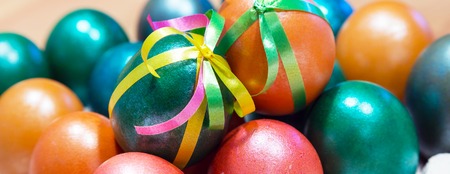 Brightly colored bow decorated easter eggs holiday panoramic banner backgroundの写真素材