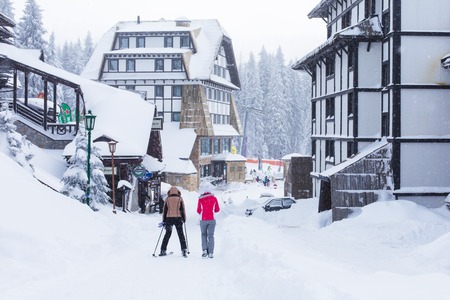 Kopaonik, Serbia - January 18, 2016: Panorama of ski resort Kopaonik during snowfall, houses, skiers, snowy trees at winter timeのeditorial素材