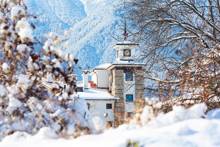 Wooden chalet with tower and snow mountains panorama in bulgarian ski resort Bansko, Bulgariaの写真素材