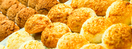 Many baked cakes on tray closeup banner food pastry backgroundの写真素材