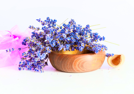 Making aroma bags, bunch of dry wild mountain lavender flowers and wooden bowlの写真素材