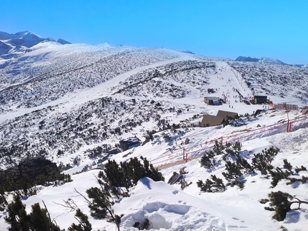 Panorama of winter mountains over the clouds, ski slopes in bulgarian alpine ski resort Borovetsの写真素材