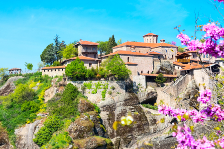 Great Meteoro Monastery in Meteora, Trikkala, Greece and branch of spring pink blossomの写真素材