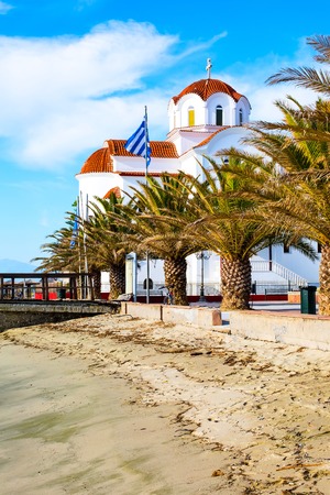 Greek orthodox Church in Paralia Katerini, wooden pier, palm trees and sandy beach, Greeceの写真素材
