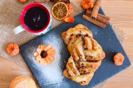 marple and pecan plait pastry sweet food breakfast with tea cup and flowerの写真素材