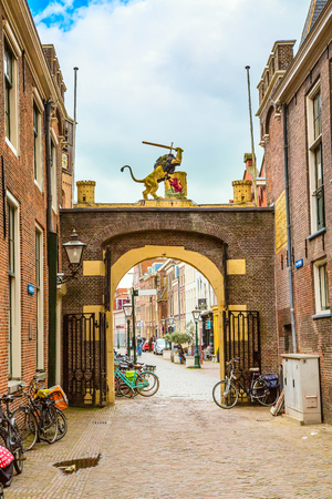 Arch and street view, traditional houses and bicycles in Leiden, Hollandの写真素材