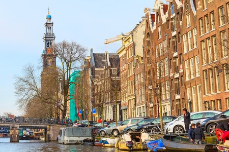Amsterdam, Netherlands - April 1, 2016: Westerkerk or Western Church tower and dutch houses in Amsterdam, Hollandのeditorial素材