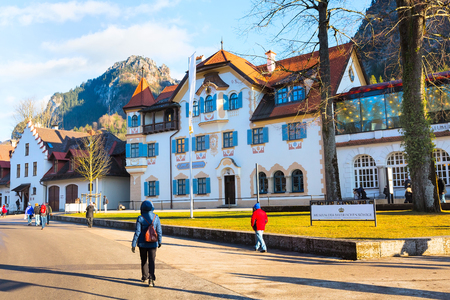 Fussen, Germany - December 27, 2016: Beautiful painted traditional bavarian house and people near Neuschwanstein and german alps in Bavariaのeditorial素材
