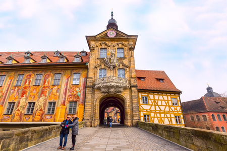 Bamberg, Germany - February 19, 2017: Icon of Bamberg Obere bridge or brucke and Altes Rathaus town hall city center, peopleのeditorial素材