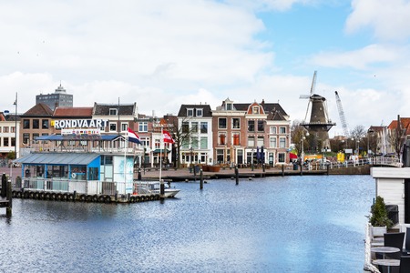 Leiden, Netherlands - April 7, 2016: Traditional houses, canal and windmill in Leiden, Hollandのeditorial素材
